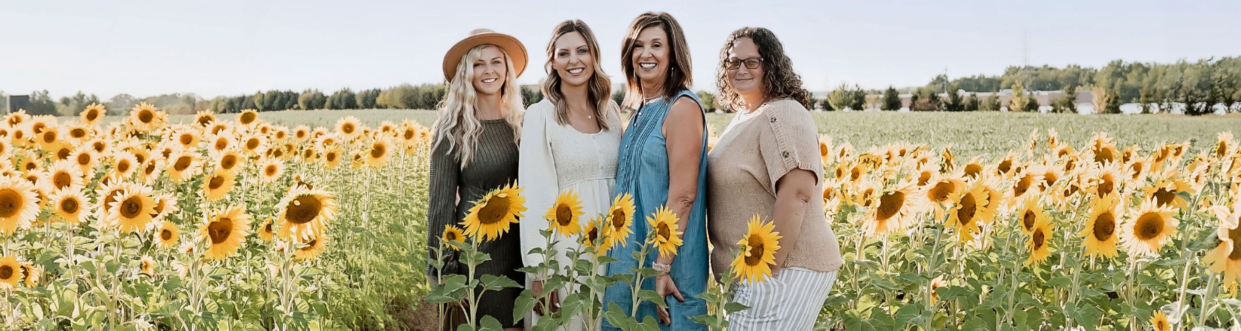 Members of the Willy’s World team together in a sunflower field